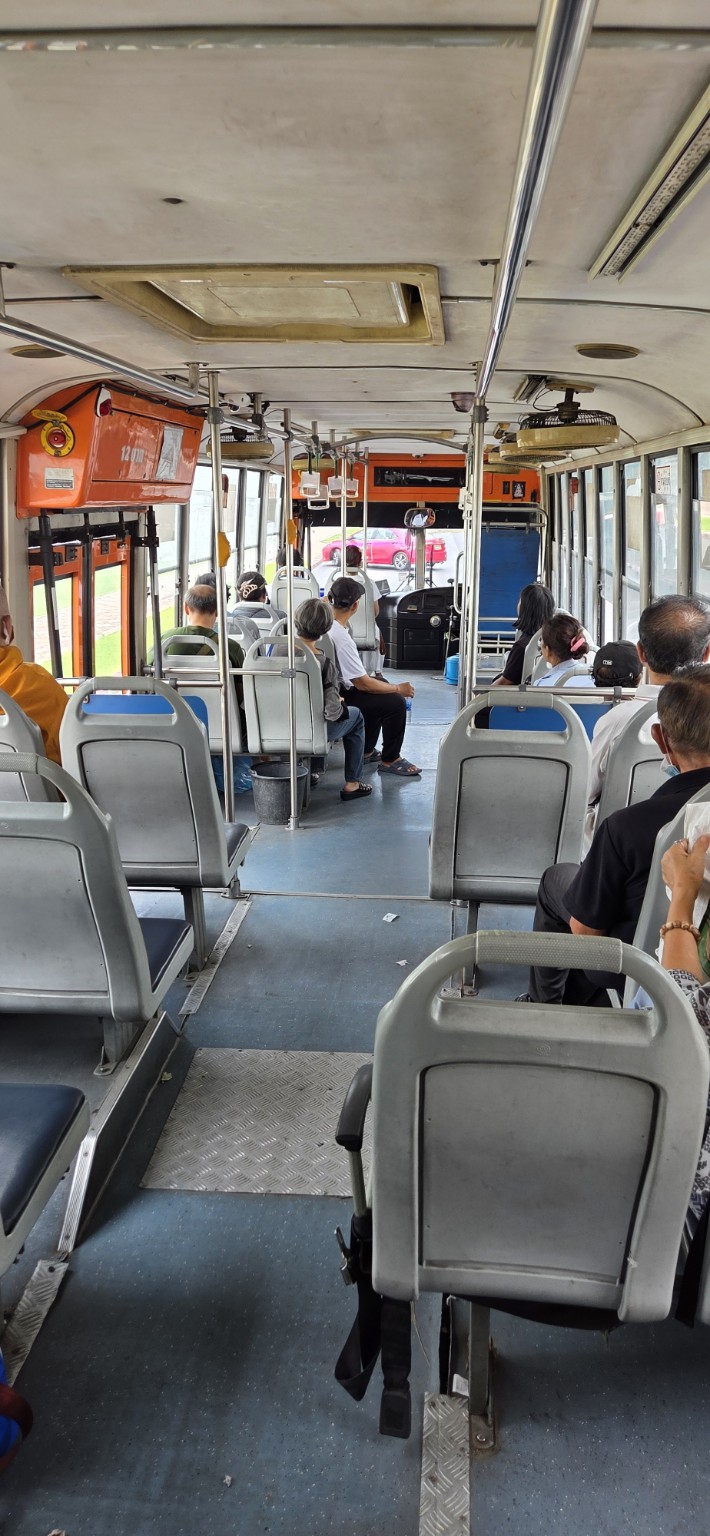 Passengers riding a local Bangkok bus